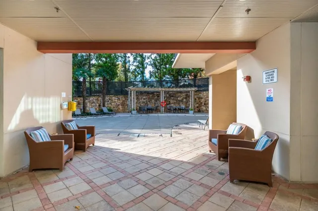 a view of a pathway with a bench in front of house