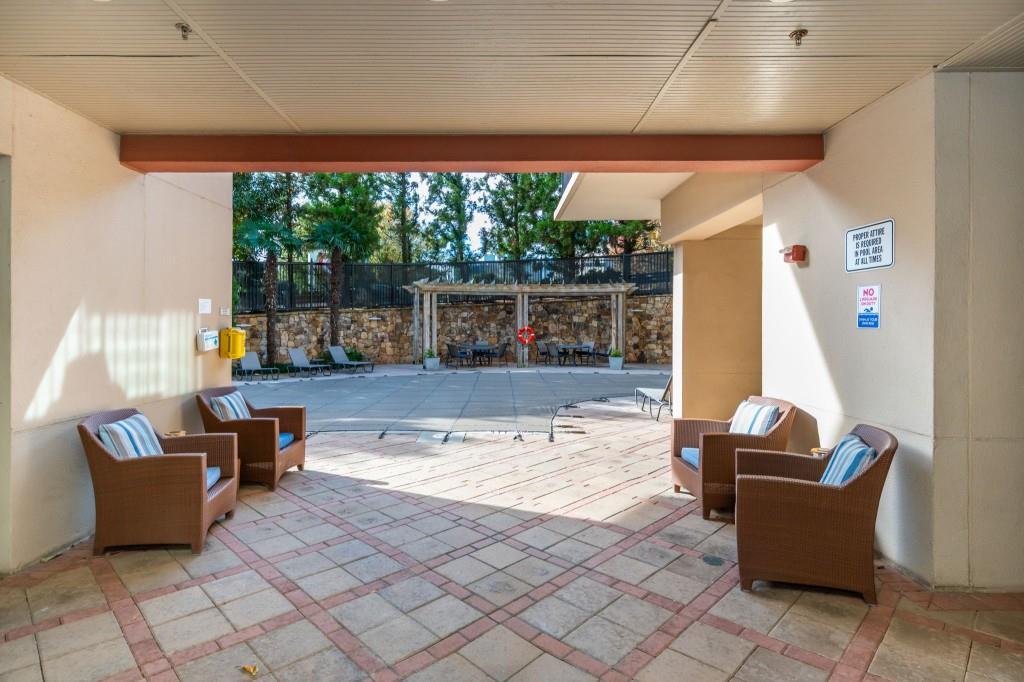 4561 Olde Perimeter Way, Unit 1701 Atlanta, GA 30346 - Photo 37 of 60 a living room with furniture and large windows