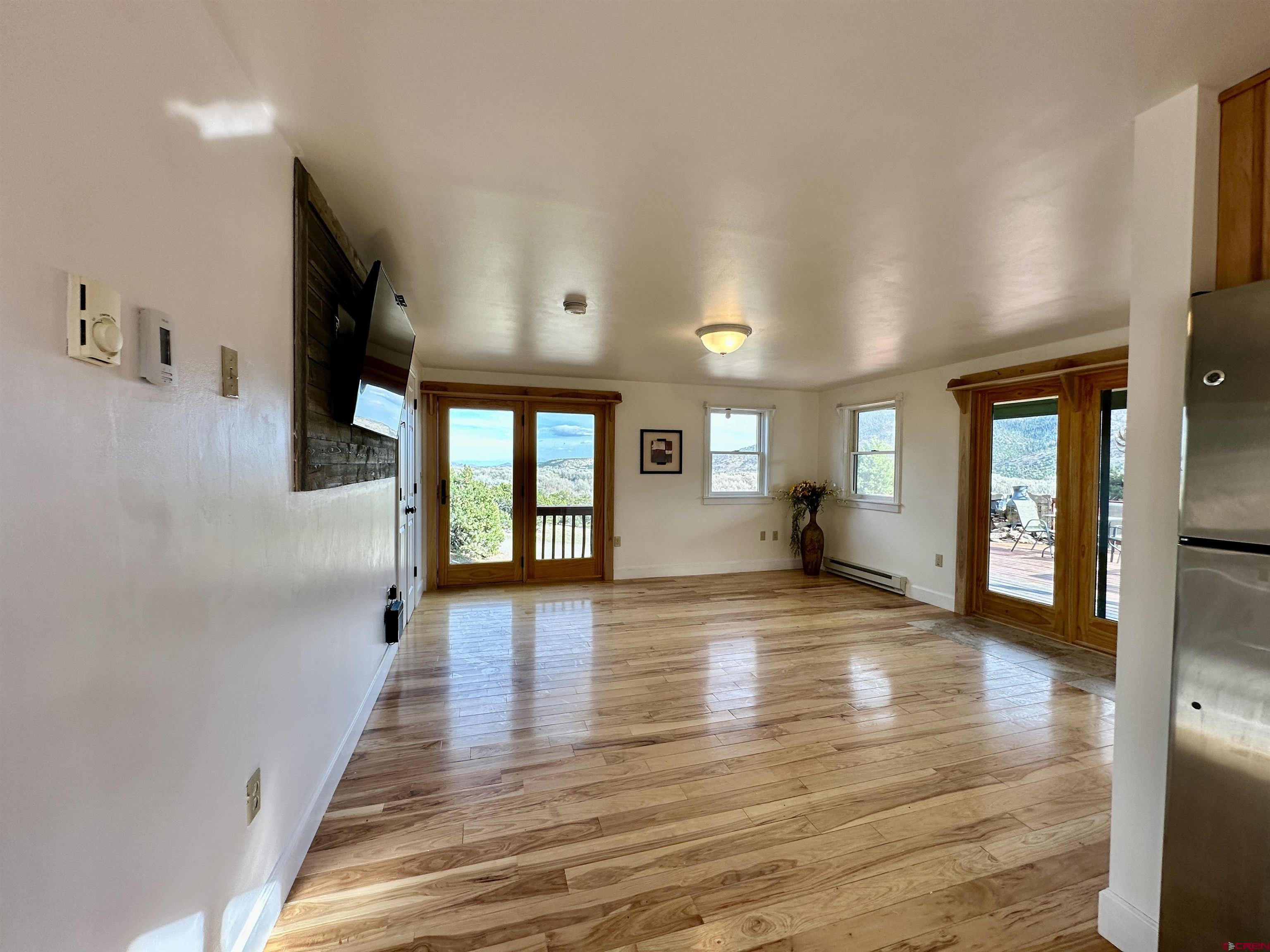 351 Loveland Road South Fork, CO 81154 - Photo 15 of 45 a view of empty room with wooden floor and fan