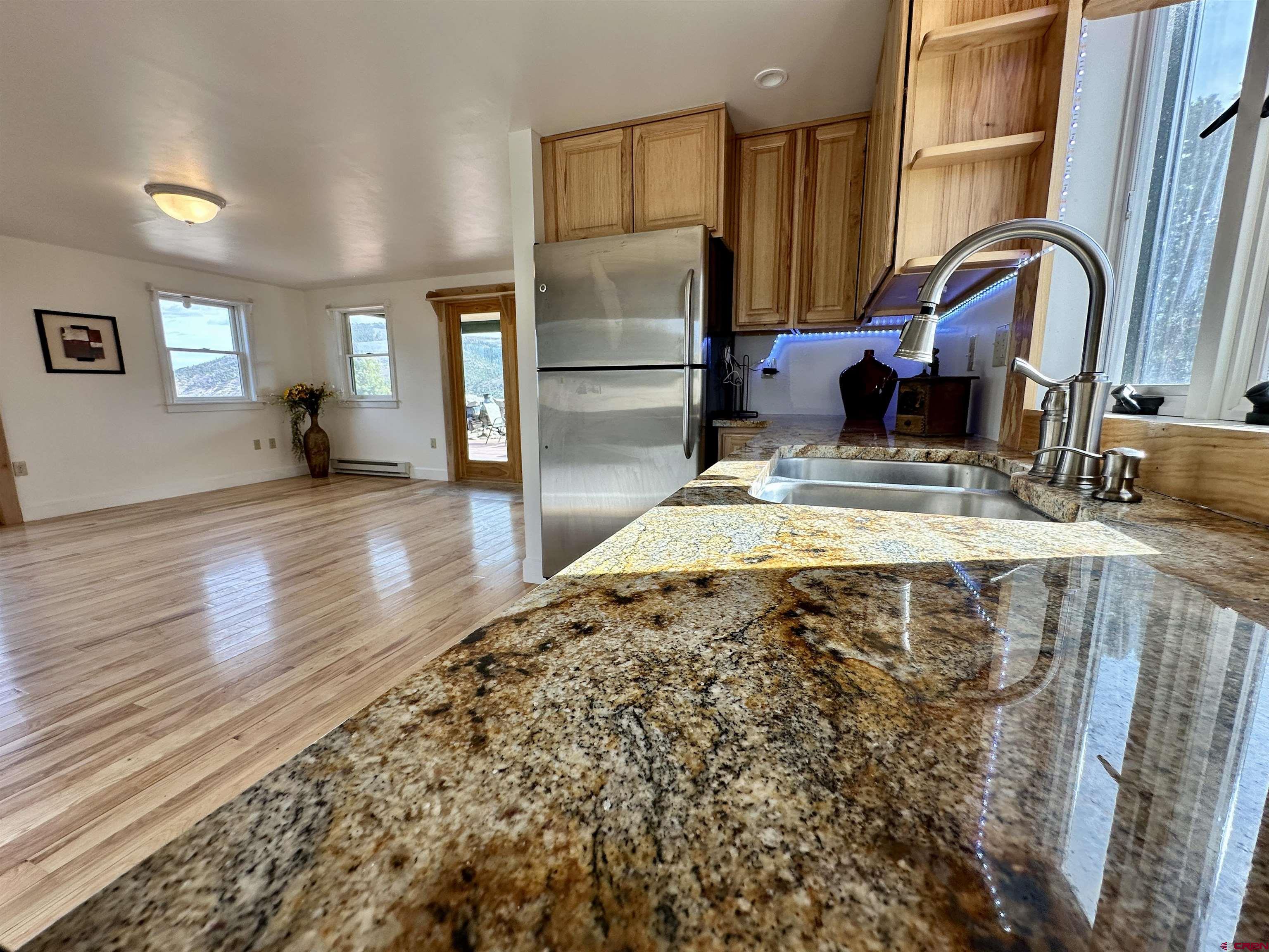 351 Loveland Road South Fork, CO 81154 - Photo 17 of 45 a kitchen with stainless steel appliances granite countertop a refrigerator and a sink