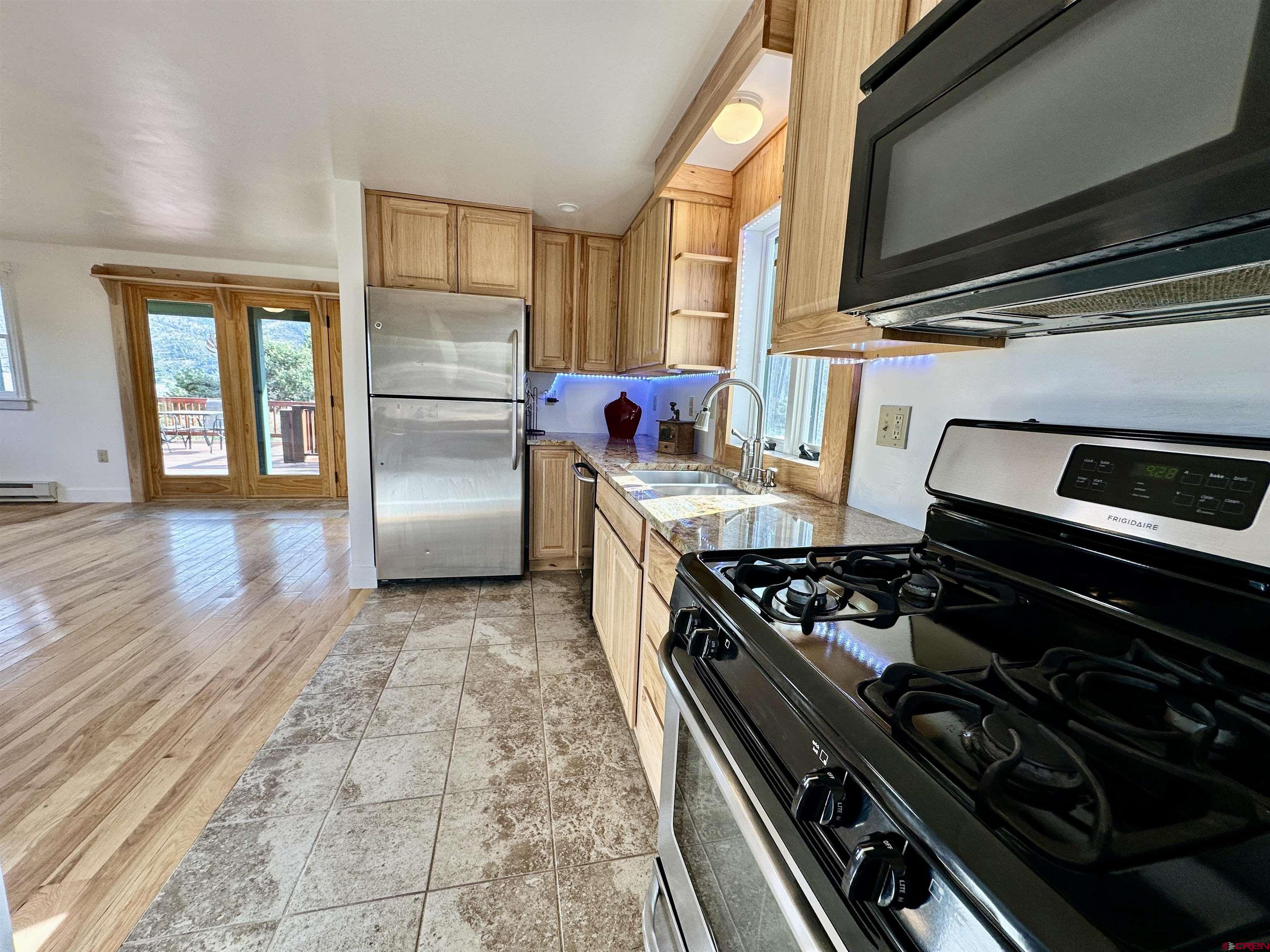 351 Loveland Road South Fork, CO 81154 - Photo 18 of 45 a kitchen with granite countertop stainless steel appliances and wooden cabinets
