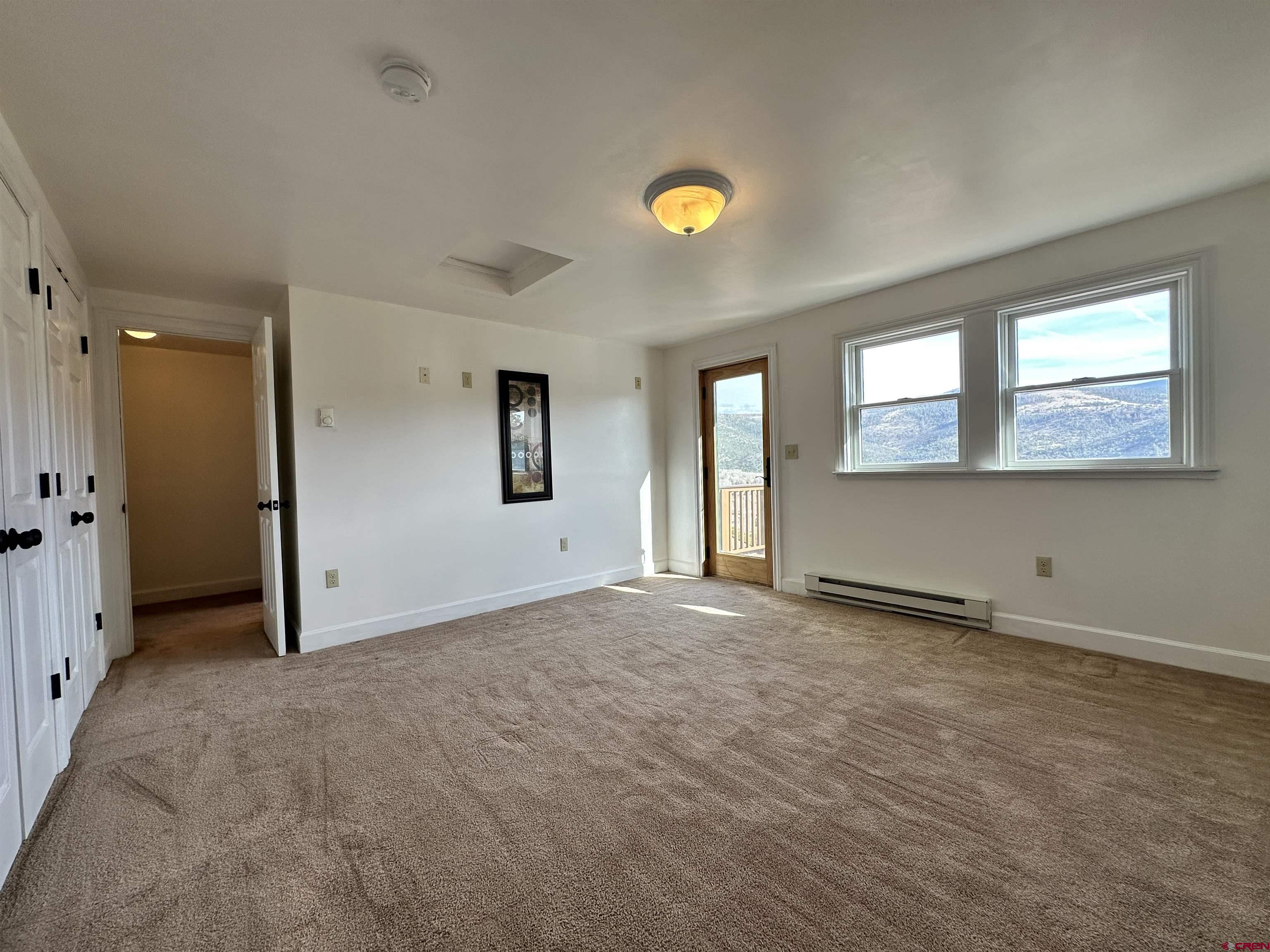 351 Loveland Road South Fork, CO 81154 - Photo 24 of 45 an empty room with windows and entrance