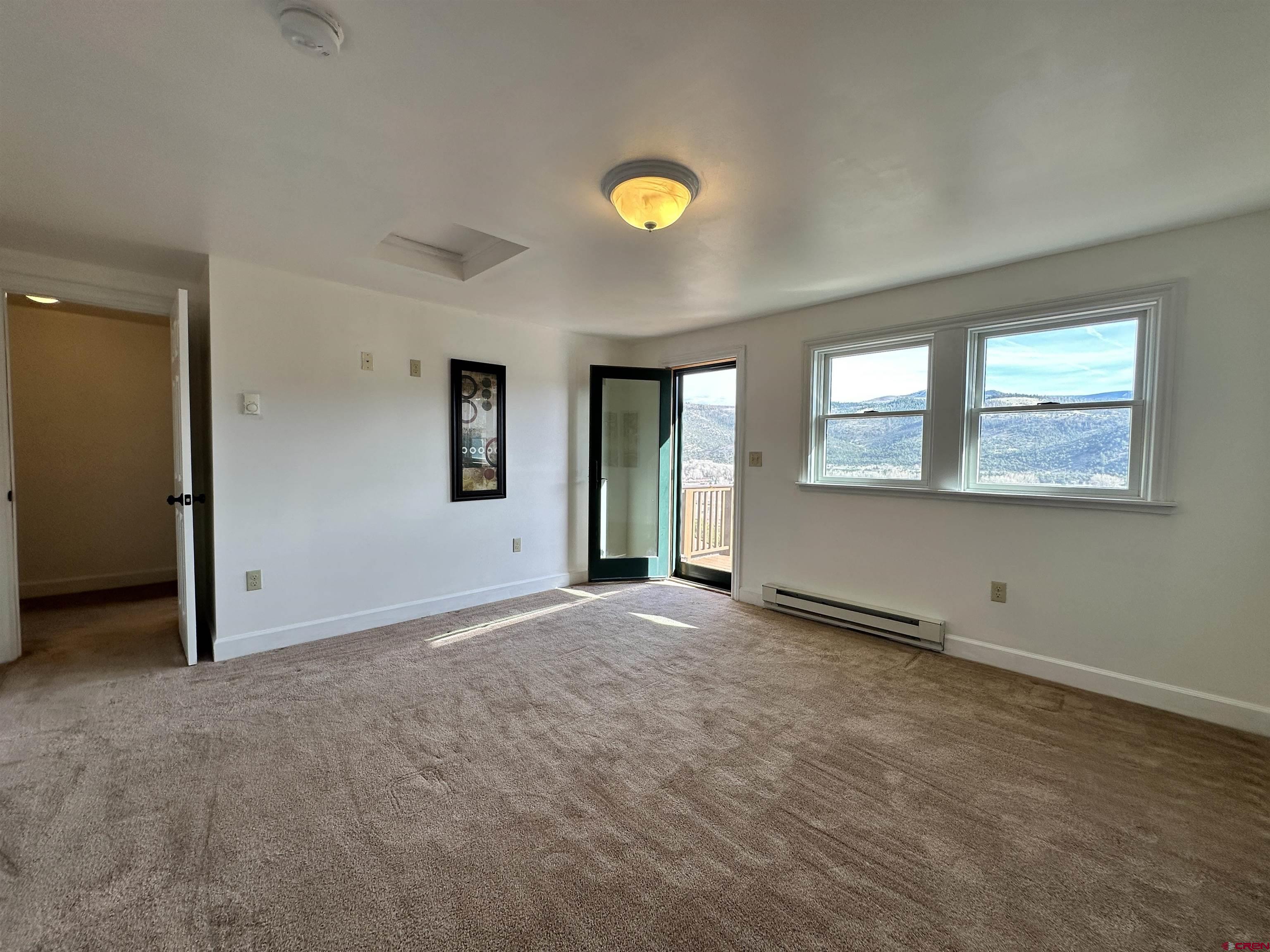 351 Loveland Road South Fork, CO 81154 - Photo 28 of 45 an empty room with windows and mirror