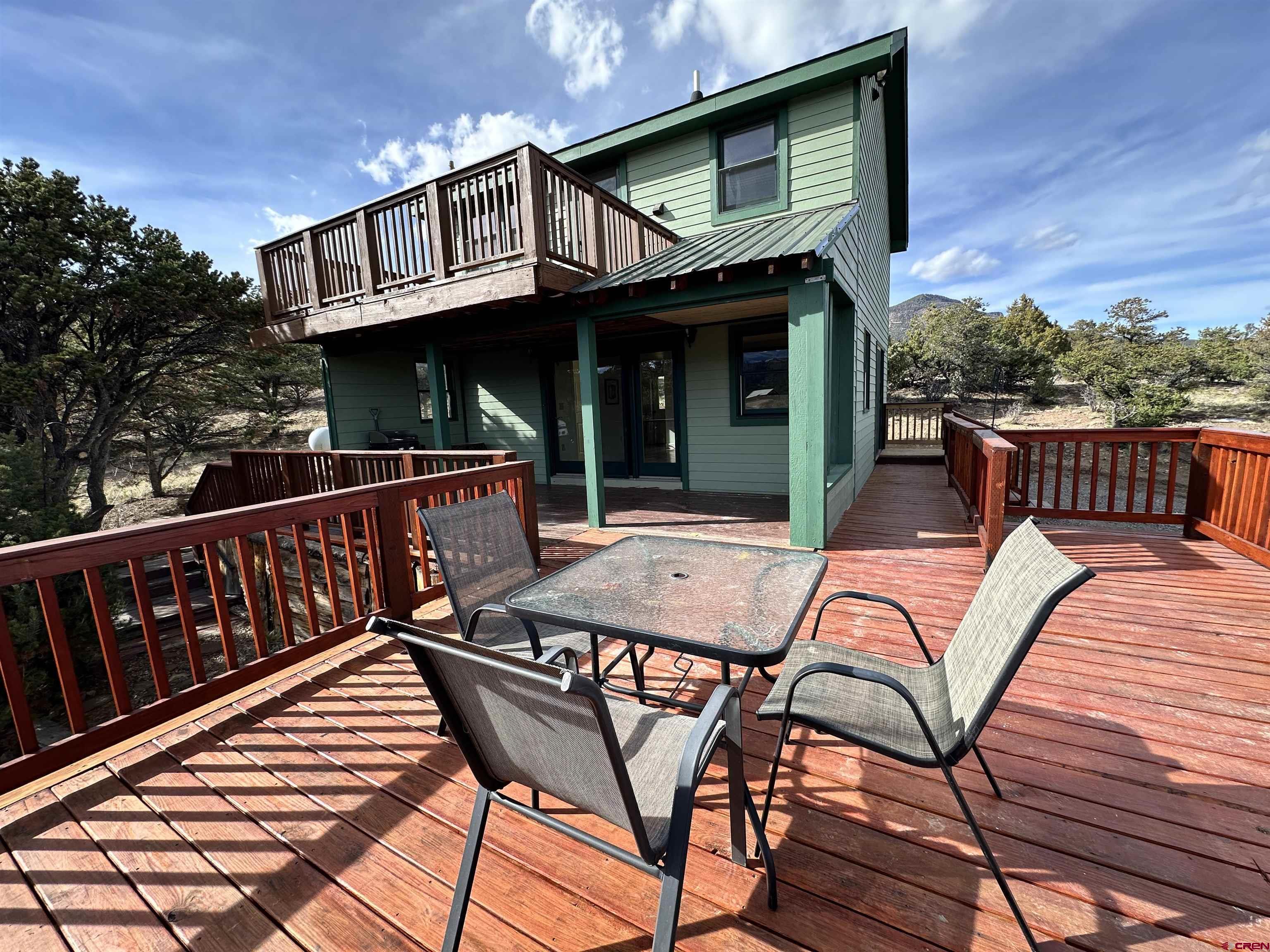 351 Loveland Road South Fork, CO 81154 - Photo 37 of 45 a view of a wooden chairs and table on the deck