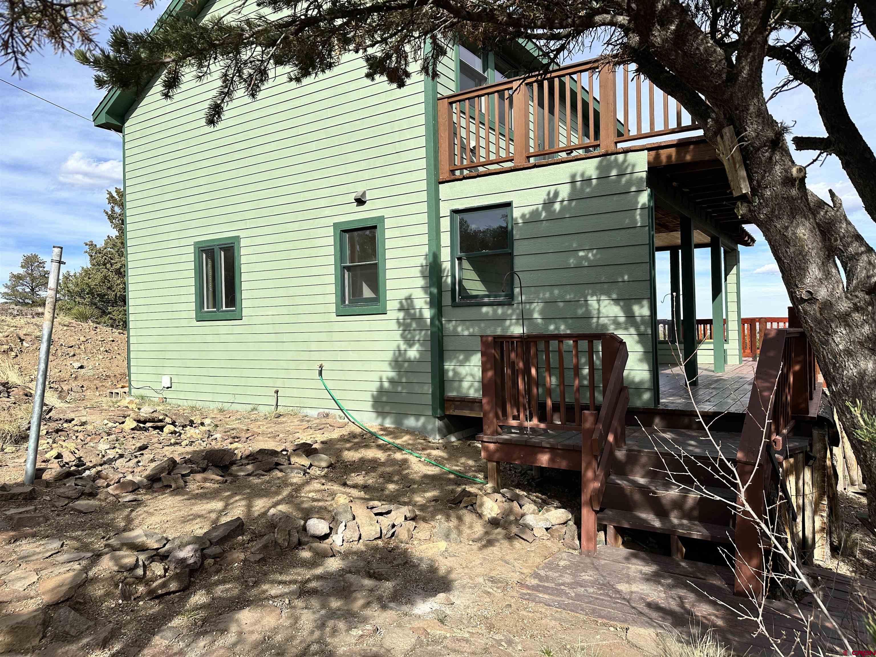 351 Loveland Road South Fork, CO 81154 - Photo 4 of 45 a view of a house with a yard and a tree