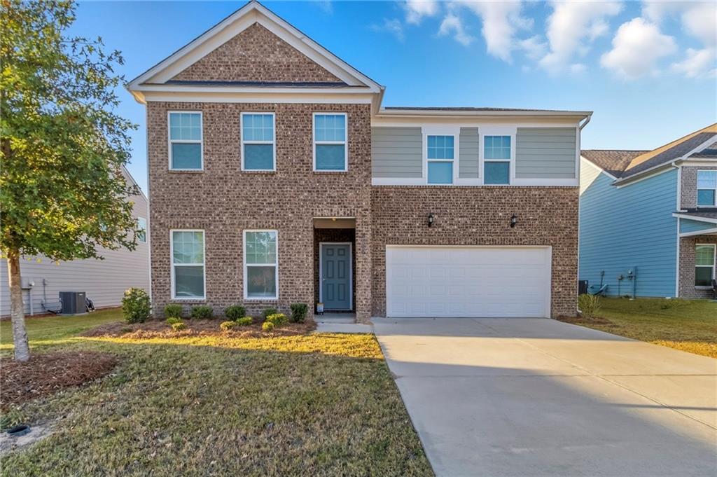 a front view of a house with a yard
