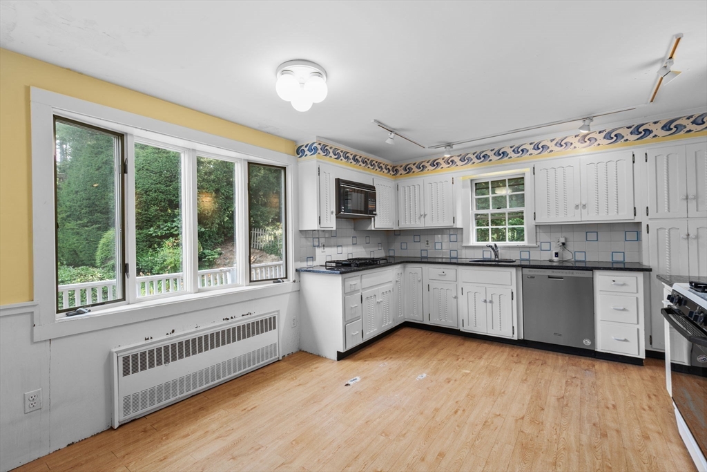 26 Holman Road Newton, MA 02466 - Photo 12 of 42 a large white kitchen with granite countertop a large window and a sink