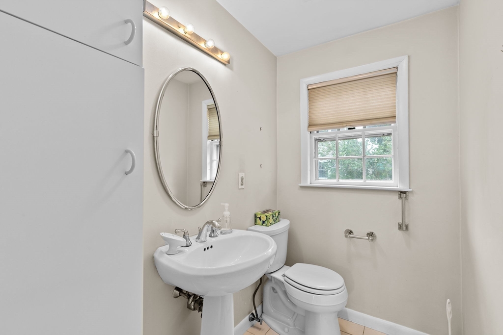 26 Holman Road Newton, MA 02466 - Photo 14 of 42 a bathroom with a toilet sink and mirror