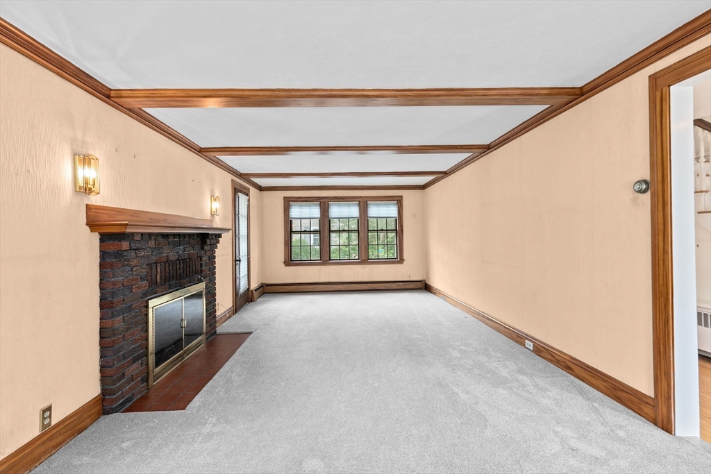 26 Holman Road Newton, MA 02466 - Photo 16 of 42 a view of an empty room with a fireplace and a window