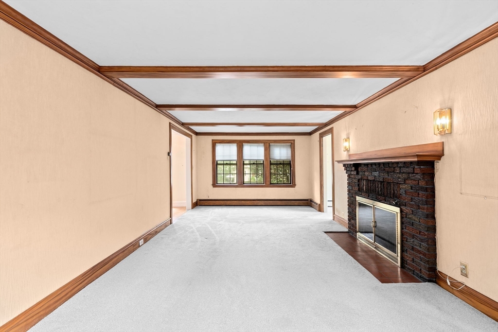 26 Holman Road Newton, MA 02466 - Photo 17 of 42 a view of an empty room with a fireplace and a window