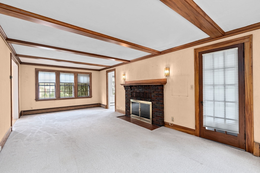 26 Holman Road Newton, MA 02466 - Photo 18 of 42 a view of an empty room with a fireplace and a window