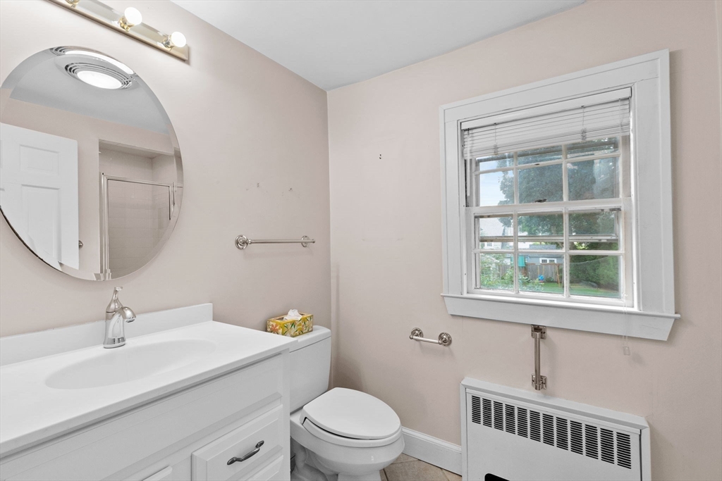 26 Holman Road Newton, MA 02466 - Photo 25 of 42 a bathroom with a sink a toilet and a mirror