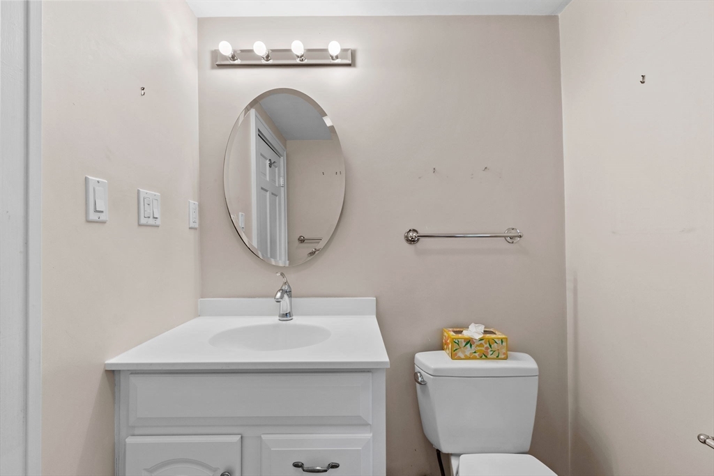 26 Holman Road Newton, MA 02466 - Photo 26 of 42 a bathroom with a sink a toilet and a mirror