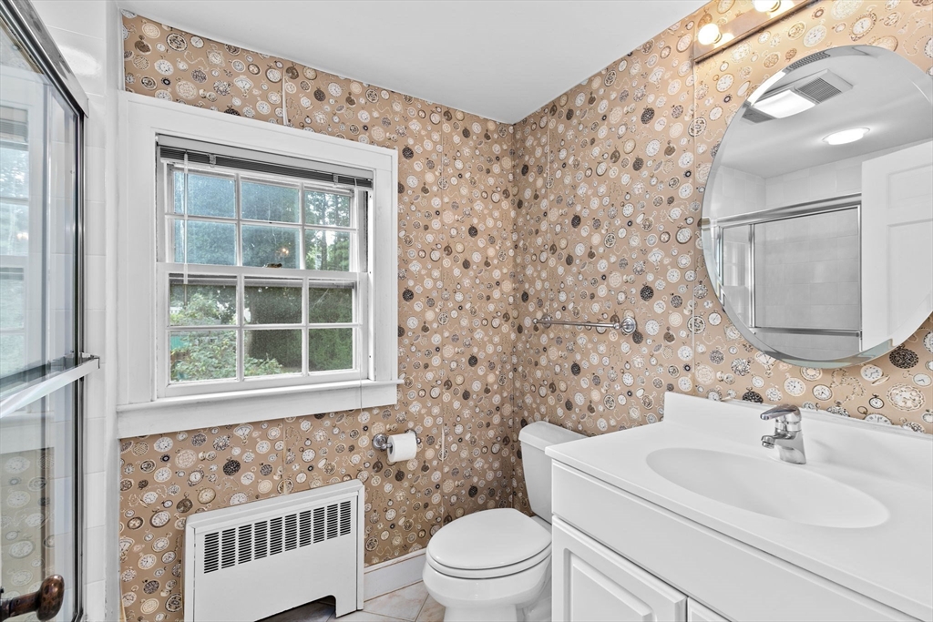 26 Holman Road Newton, MA 02466 - Photo 30 of 42 a bathroom with a sink a toilet and a mirror