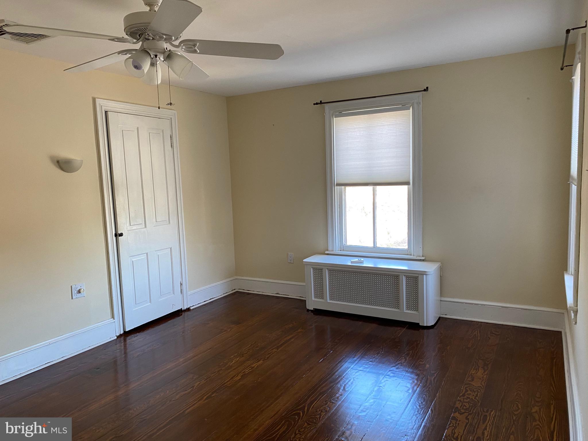 17 Walnut Street Haddonfield, NJ 08033 - Photo 3 of 9 an empty room with wooden floor cabinet and windows