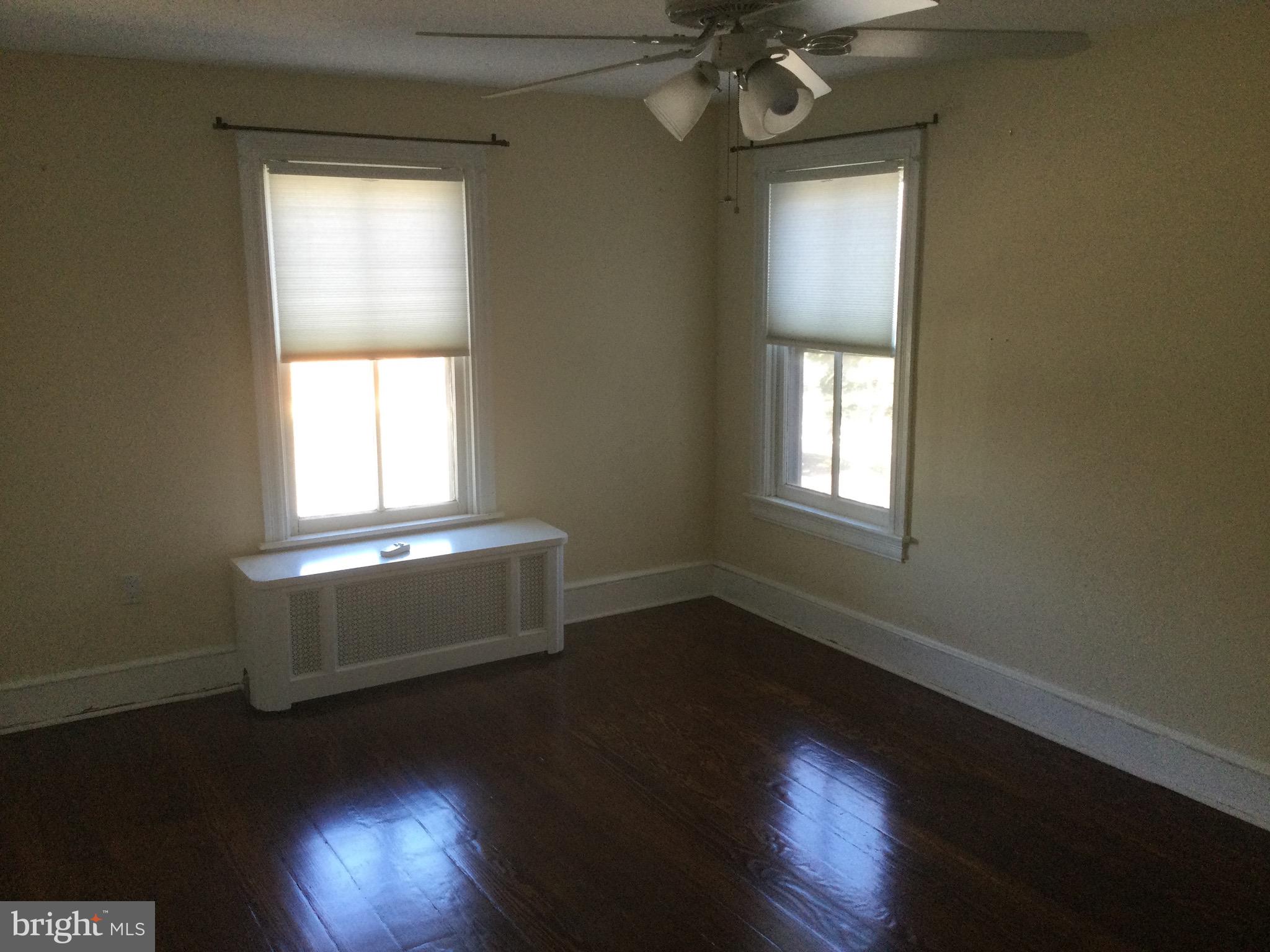 17 Walnut Street Haddonfield, NJ 08033 - Photo 4 of 9 an empty room with wooden floor and windows