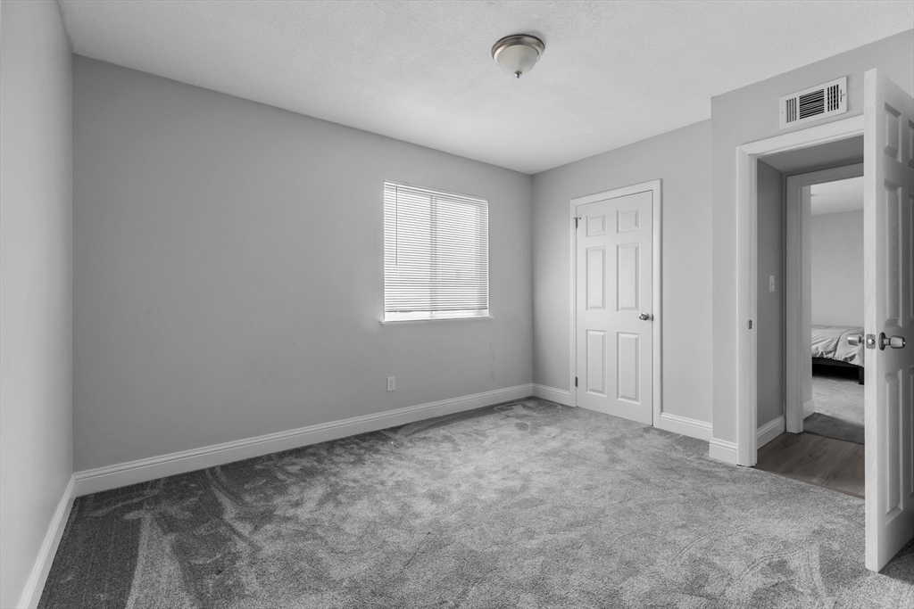 239 Glasgow Street, Unit 12 Fall River, MA 02721 - Photo 18 of 29 a view of an empty room with closet and a window