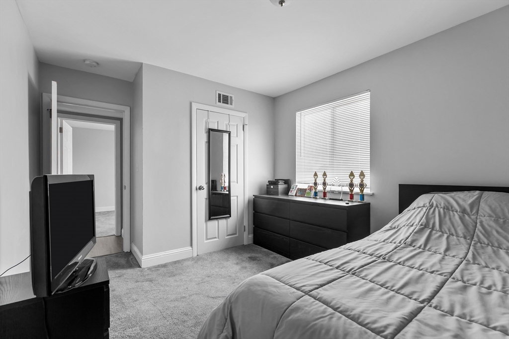 239 Glasgow Street, Unit 12 Fall River, MA 02721 - Photo 21 of 29 a bed room with a bed and a television