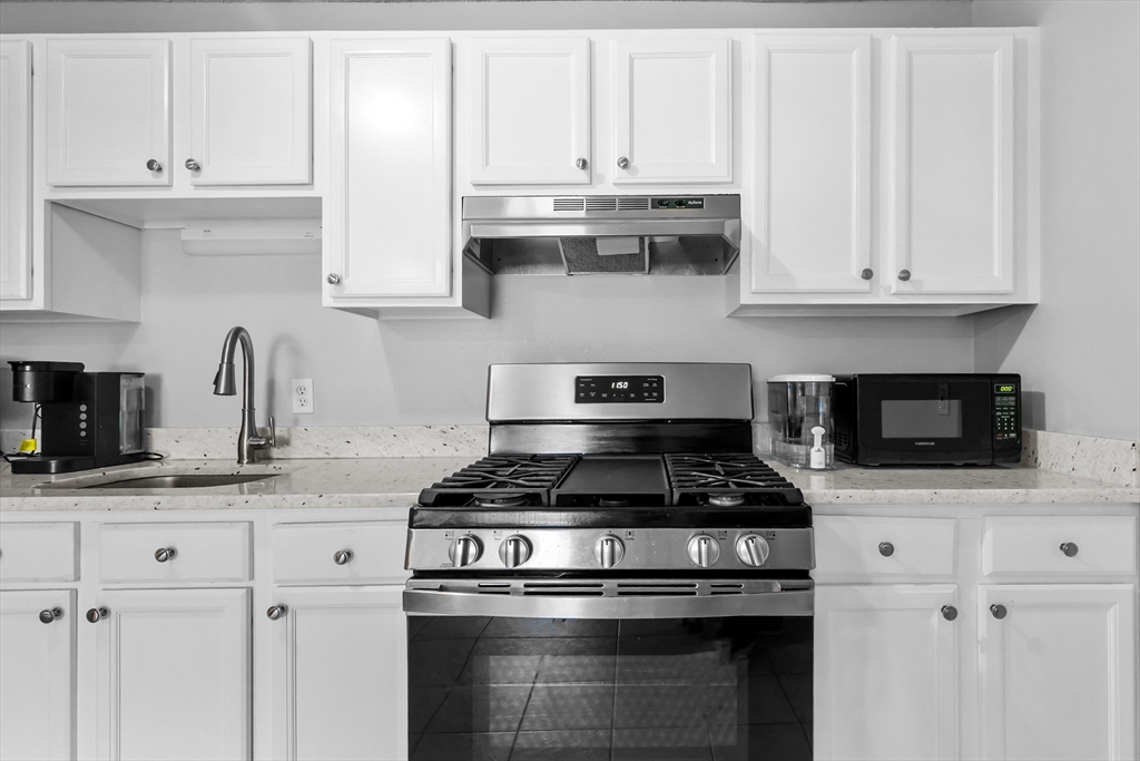 239 Glasgow Street, Unit 12 Fall River, MA 02721 - Photo 29 of 29 a kitchen with white cabinets and appliances