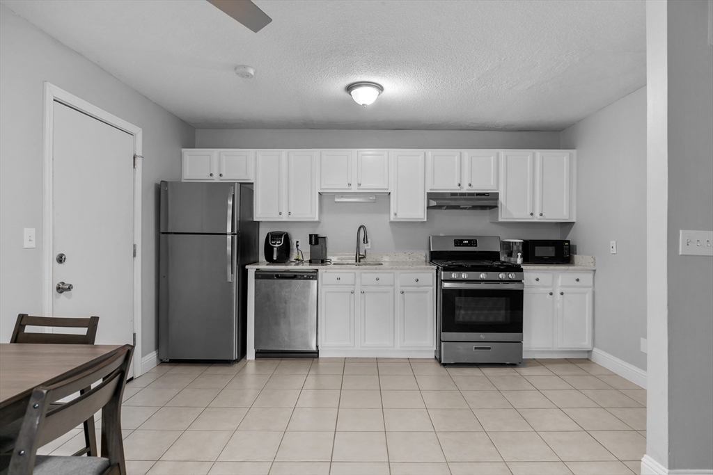 239 Glasgow Street, Unit 12 Fall River, MA 02721 - Photo 3 of 29 a kitchen with a stove a refrigerator and a sink