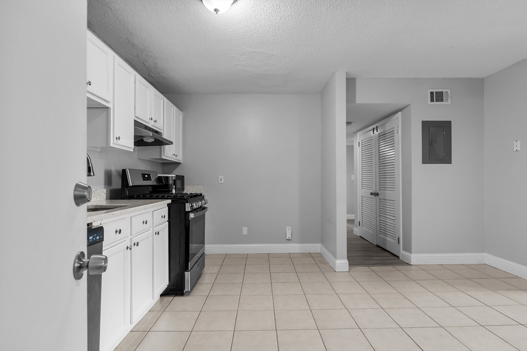 239 Glasgow Street, Unit 12 Fall River, MA 02721 - Photo 4 of 29 a kitchen with a refrigerator and a stove top oven