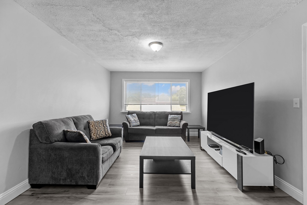 239 Glasgow Street, Unit 12 Fall River, MA 02721 - Photo 8 of 29 a living room with furniture and a flat screen tv