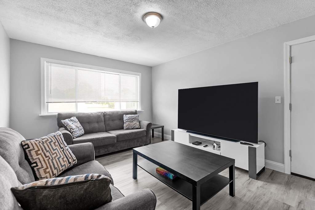 239 Glasgow Street, Unit 12 Fall River, MA 02721 - Photo 9 of 29 a living room with furniture and a flat screen tv