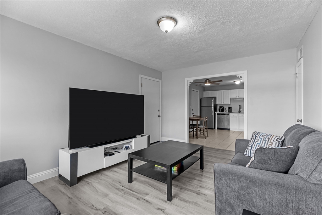 239 Glasgow Street, Unit 12 Fall River, MA 02721 - Photo 10 of 29 a living room with furniture and a flat screen tv