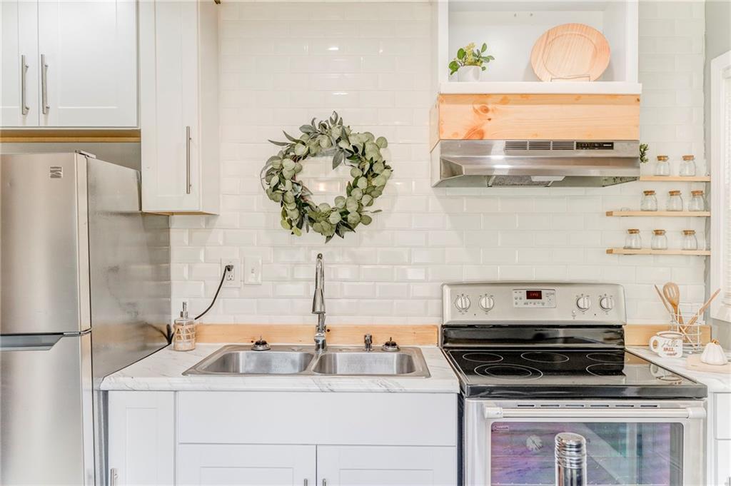 2005 Highland Circle Rome, GA 30161 - Photo 15 of 36 a kitchen with stainless steel appliances granite countertop a sink and a stove