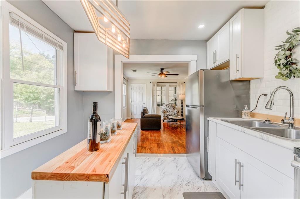 2005 Highland Circle Rome, GA 30161 - Photo 18 of 36 a kitchen with stainless steel appliances granite countertop a sink a stove and a refrigerator