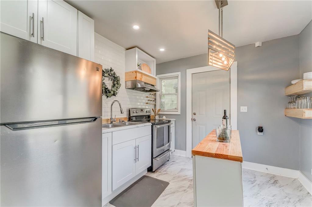 2005 Highland Circle Rome, GA 30161 - Photo 20 of 36 a kitchen with stainless steel appliances a refrigerator and a stove top oven
