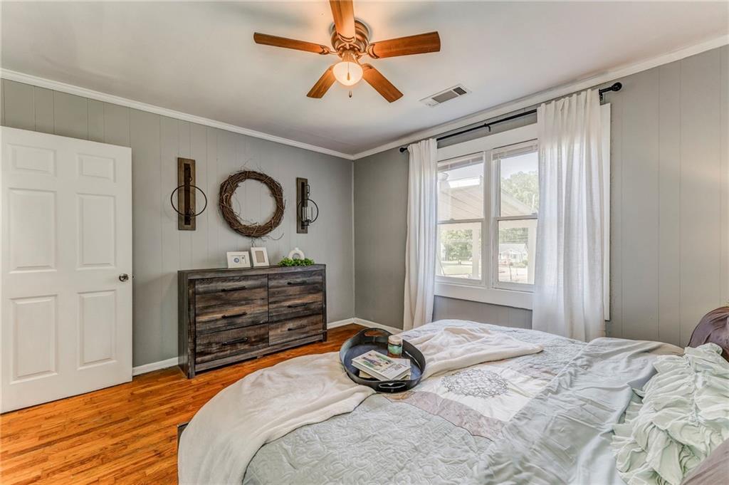 2005 Highland Circle Rome, GA 30161 - Photo 22 of 36 a bedroom with a bed and a chandelier