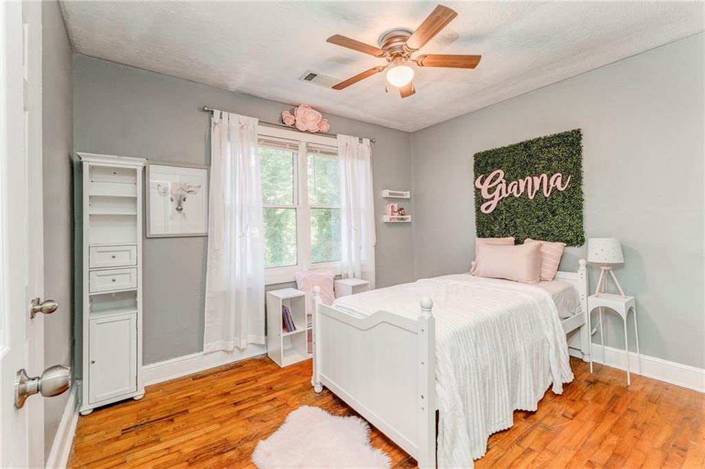 2005 Highland Circle Rome, GA 30161 - Photo 24 of 36 a bedroom with a large bed and a chandelier