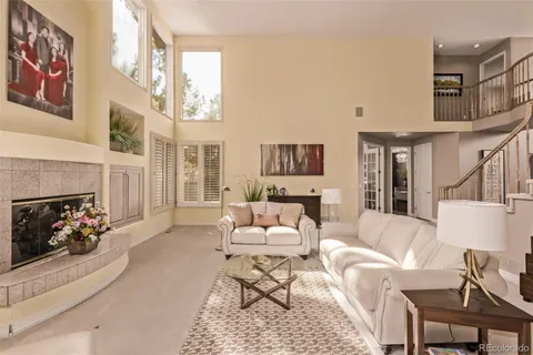 a living room with furniture fireplace and a window