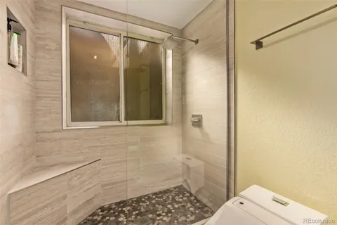 a bathroom with a shower and a toilet