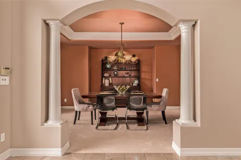 a view of a dining room with furniture and chandelier