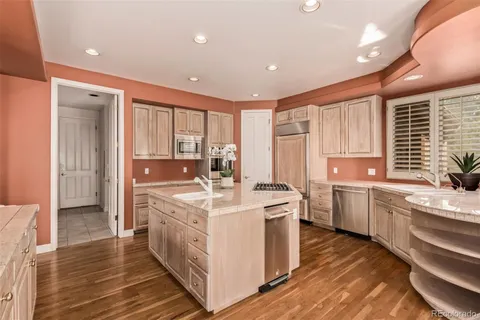 a kitchen with a stove a sink and a refrigerator