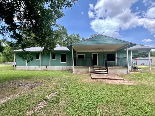 a front view of a house with a garden and porch