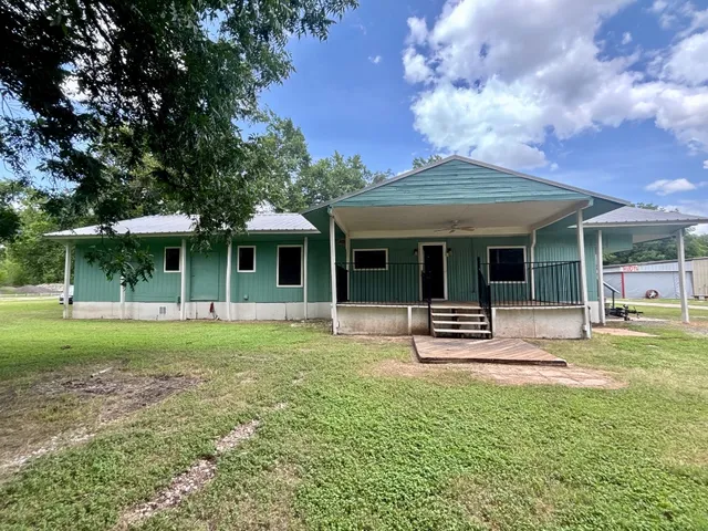 a front view of a house with a garden and porch