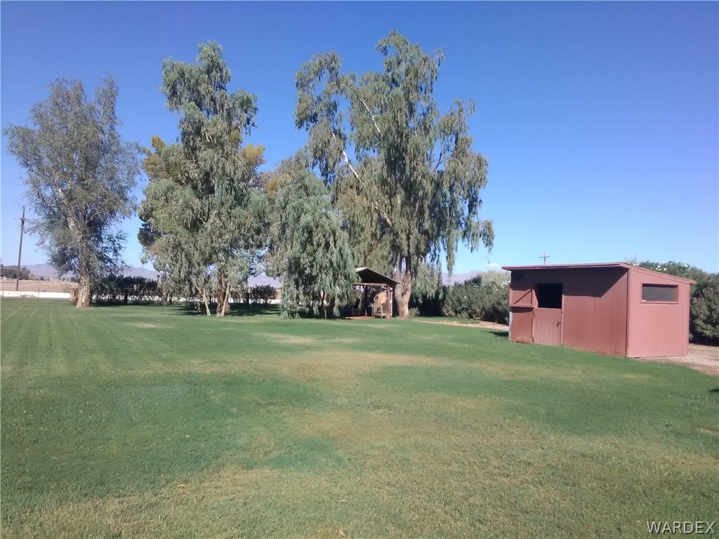 8485 Boundary Peak Road Mohave Valley, AZ 86440 - Photo 12 of 40 a front view of a house with a yard and trees