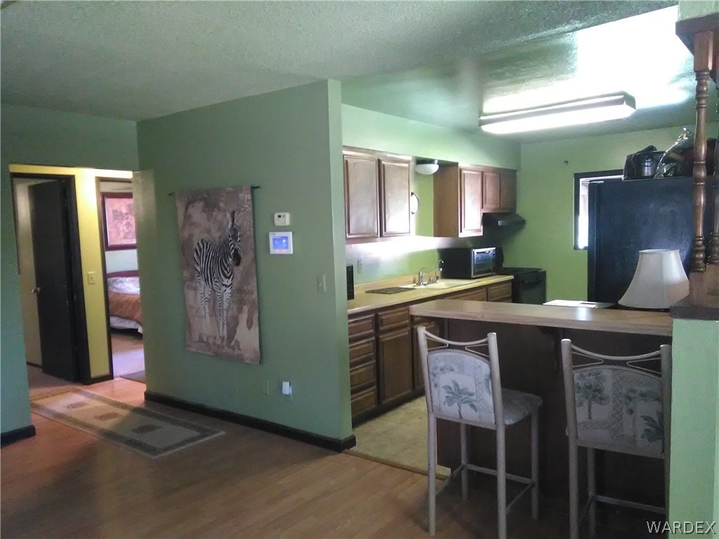 8485 Boundary Peak Road Mohave Valley, AZ 86440 - Photo 29 of 40 a kitchen with a table and chairs