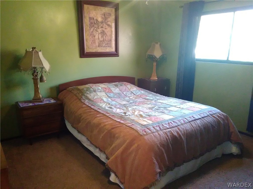 8485 Boundary Peak Road Mohave Valley, AZ 86440 - Photo 30 of 40 a bedroom with a bed and a window
