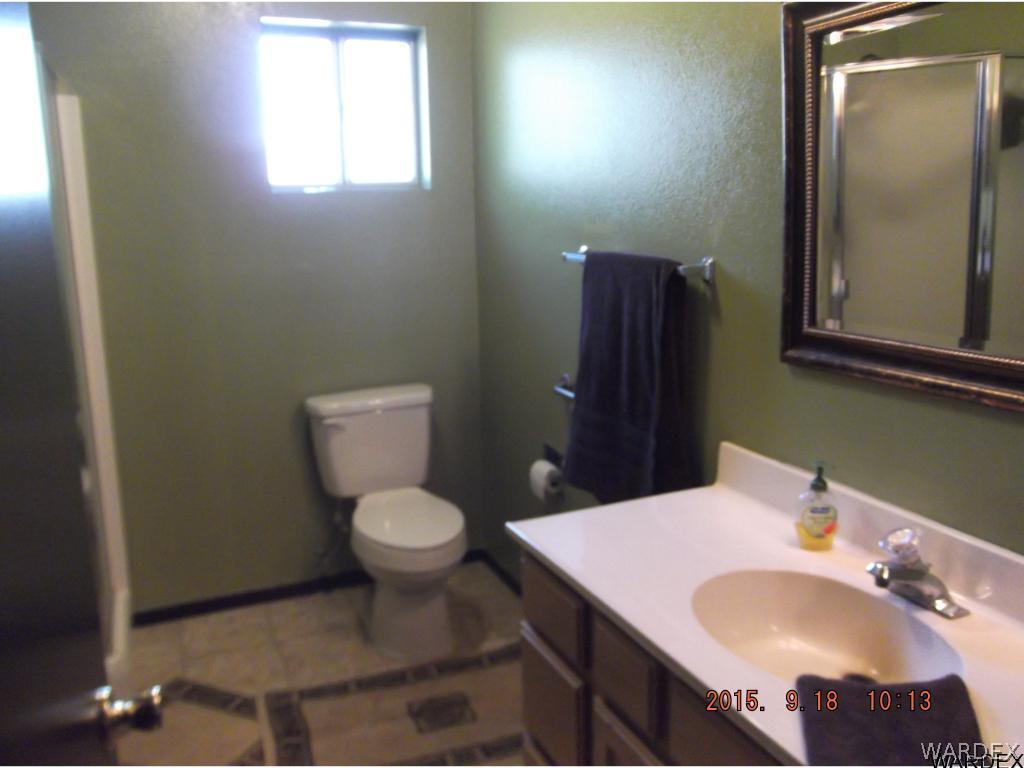 8485 Boundary Peak Road Mohave Valley, AZ 86440 - Photo 31 of 40 a bathroom with a sink toilet and mirror