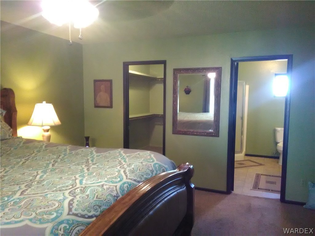 8485 Boundary Peak Road Mohave Valley, AZ 86440 - Photo 33 of 40 a bedroom with a bed and a lamp