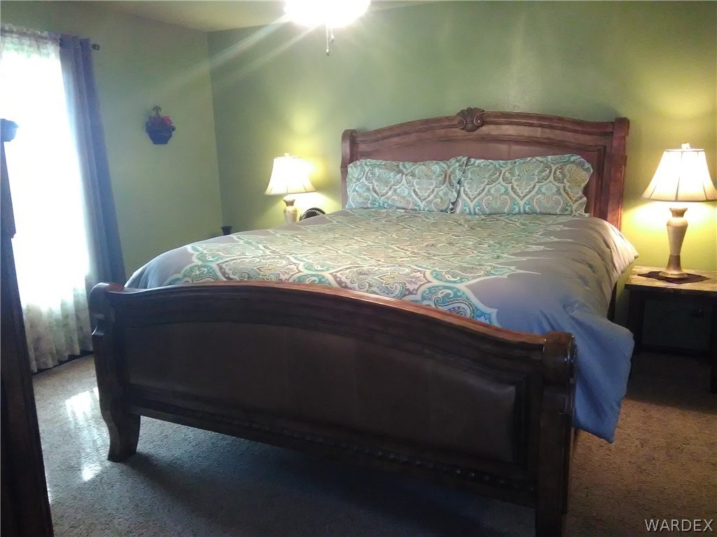 8485 Boundary Peak Road Mohave Valley, AZ 86440 - Photo 35 of 40 a bed sitting in a bedroom next to a window
