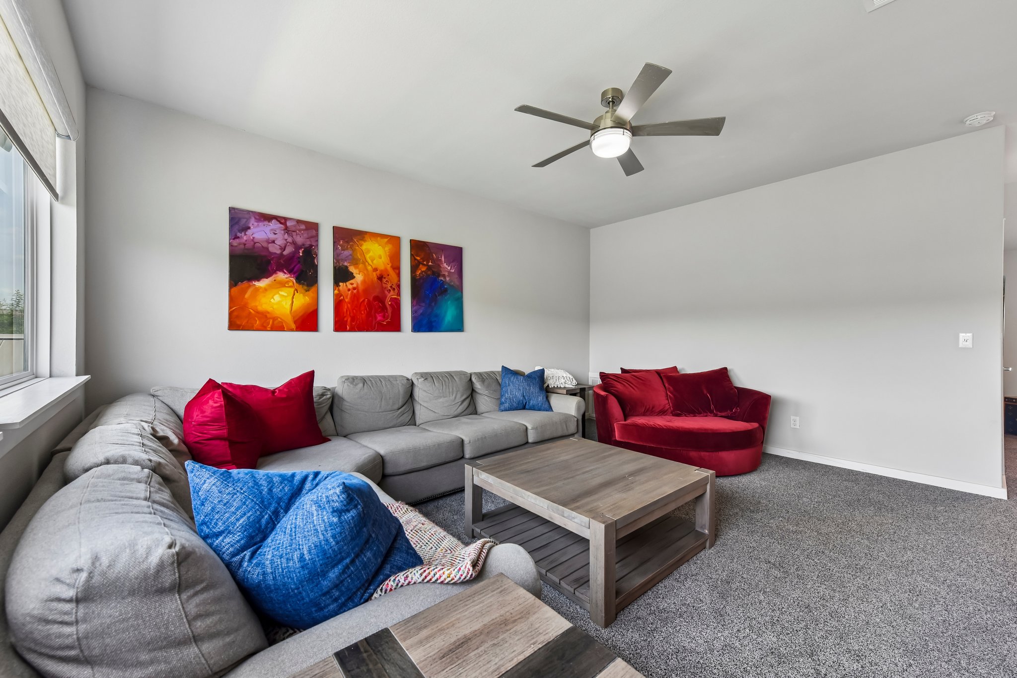 2203 Improver Road Spicewood, TX 78669 - Photo 23 of 38 A well-lit living area offers comfortable seating and a modern ceiling fan.