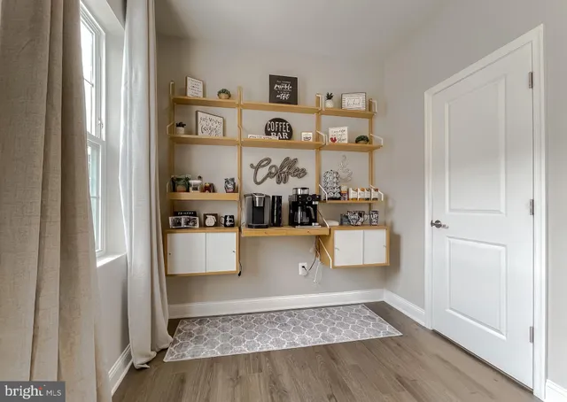 a room with wooden floor and white walls