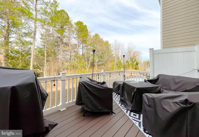 a view of a balcony with furniture and wooden floor