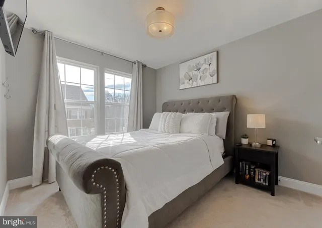 a bed sitting in a bedroom next to a window