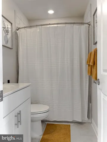 a bathroom with a shower curtain and a sink